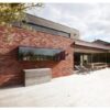 Modern brick home patio with retractable awning