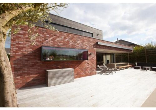 Modern brick home patio with retractable awning