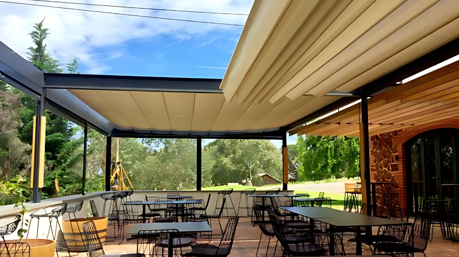 Retractable Shade sail system installed over residential outdoor lounge area