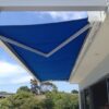 blue retractable folding arm awning