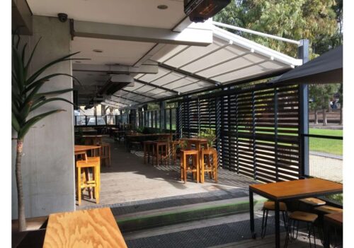 outdoor patio area equipped with a retractable roof system