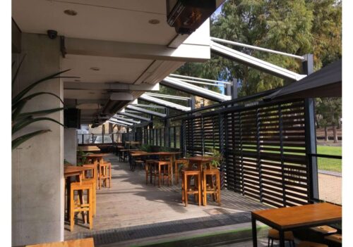 outdoor patio area equipped with a retractable roof system
