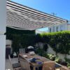 black and white striped folding arm retractable awning